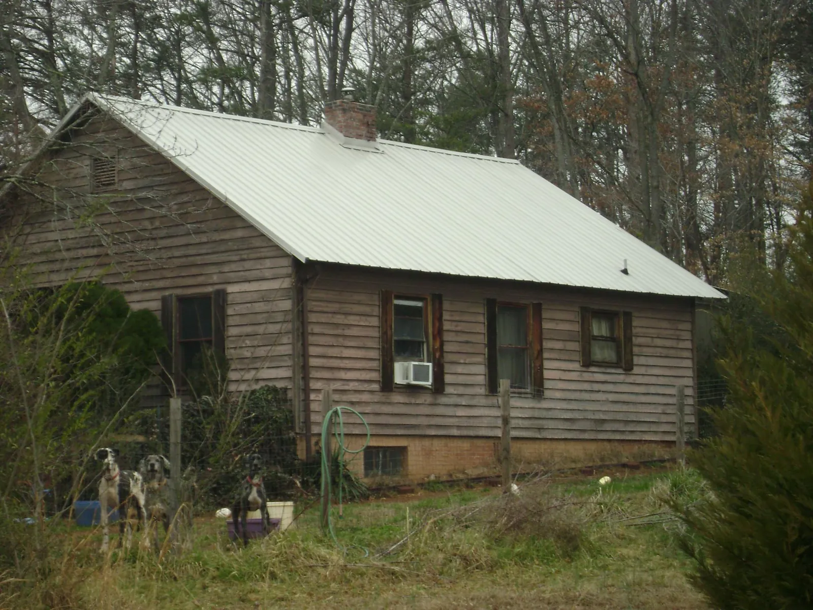 White metal roof on an old wood sided farmhouse, from a Asphalt Shingle Roof Repair job in South Lebanon